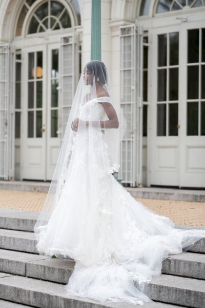 bride on her own exterior hotel pose earring detail veil