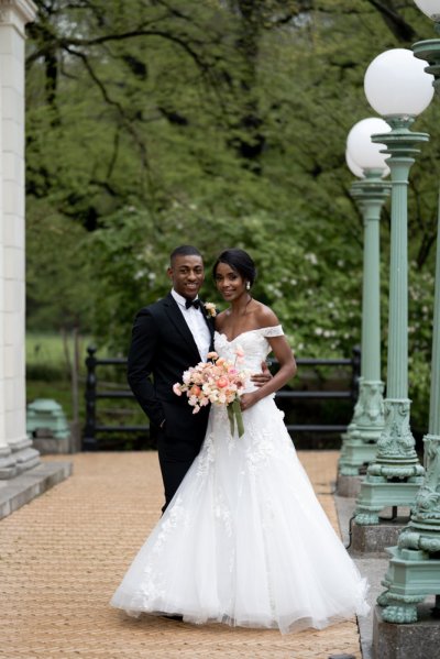 Bride and groom embrace earring detail exterior hotel flowers bouquet