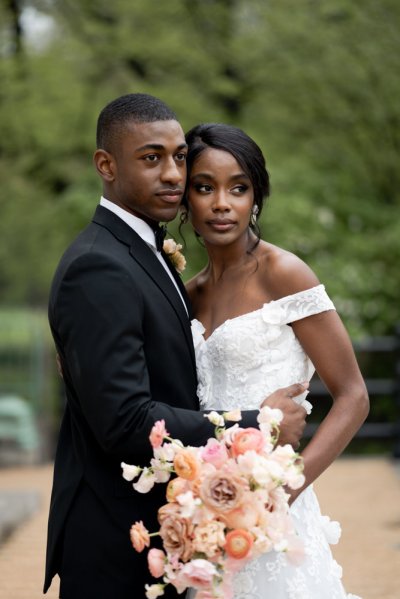 Bride and groom embrace earring detail exterior hotel flowers bouquet