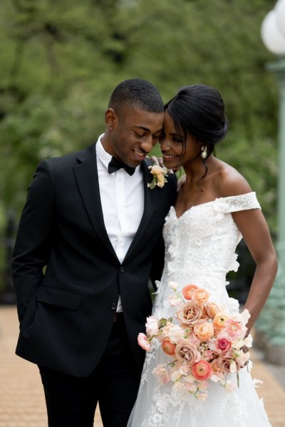 bride and groom holding flowers bouquet