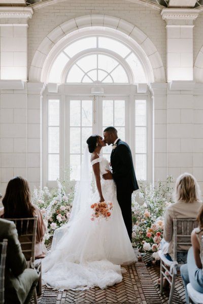 Bride and groom at the alter pink roses bouquet flowers