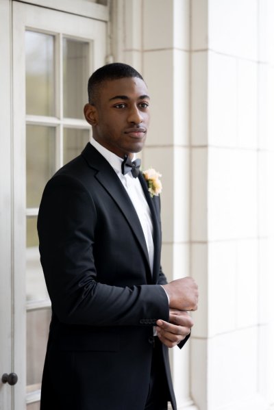 groom outside hotel exterior suit bow and tie