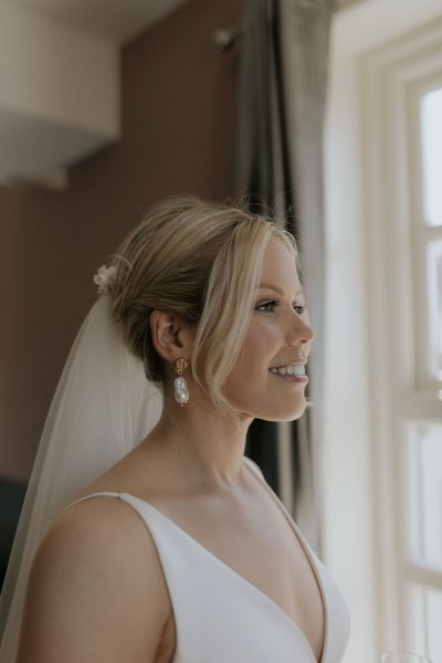 Bride getting ready looking out window