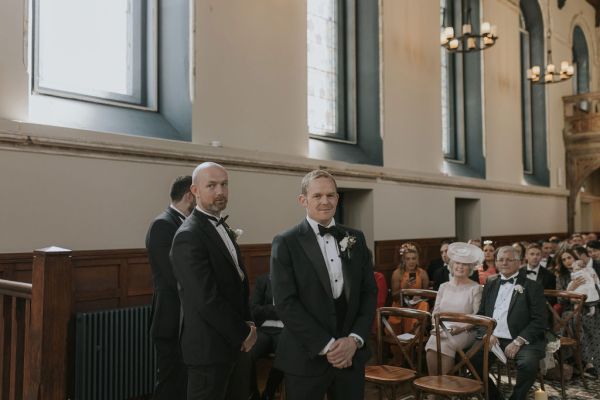 Groom and groomsman waiting at alter church