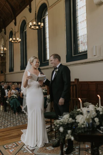 Bride groom reading speech candles flowers