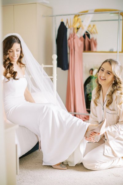 bride getting ready putting on shoes