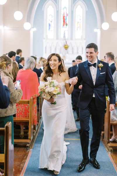 bride and groom walking down aisle