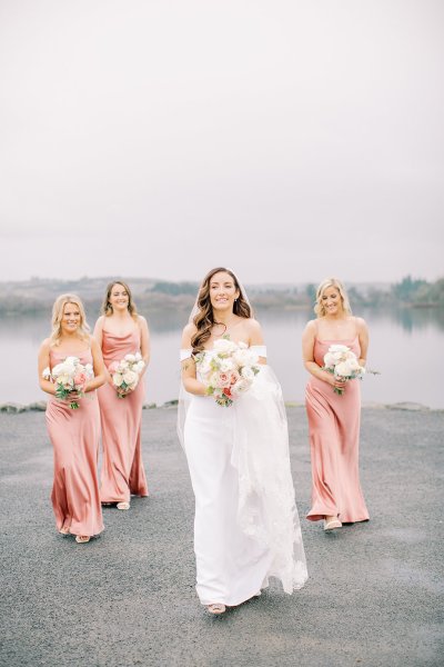 bride with peach coral bridesmaids