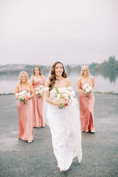 bride with peach coral bridesmaids