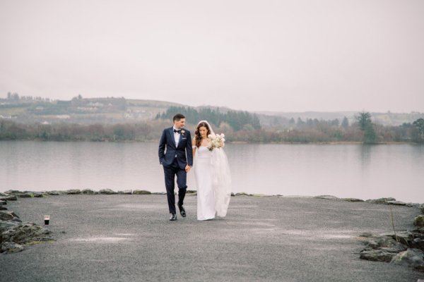 bride and groom walking rain and mist