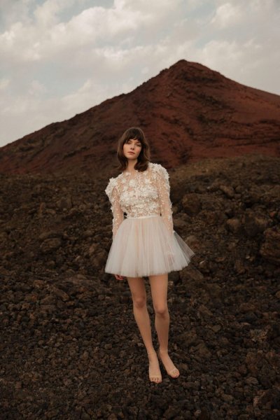 Model bride bridal gown from behind mountain beach