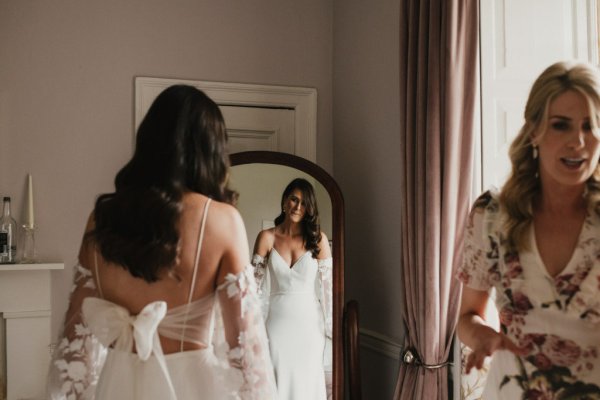 Bride getting ready lace dress detail sleeves mirror