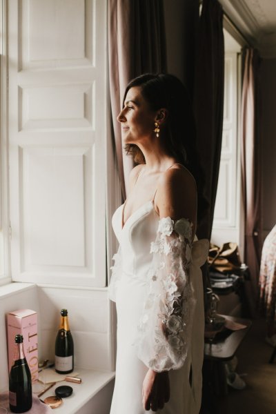 Bride ready standing beside window lace