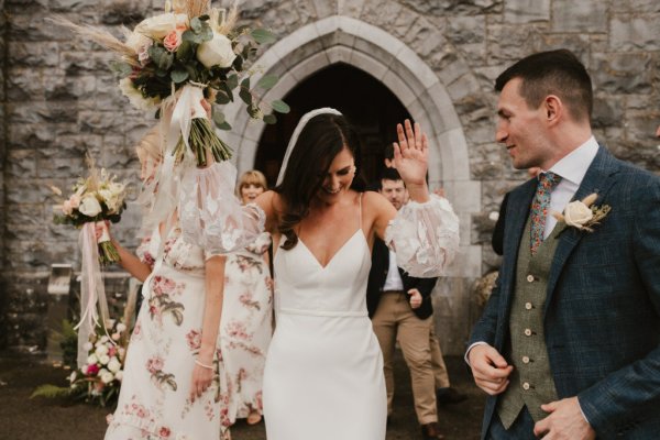 Bride exiting church flowers