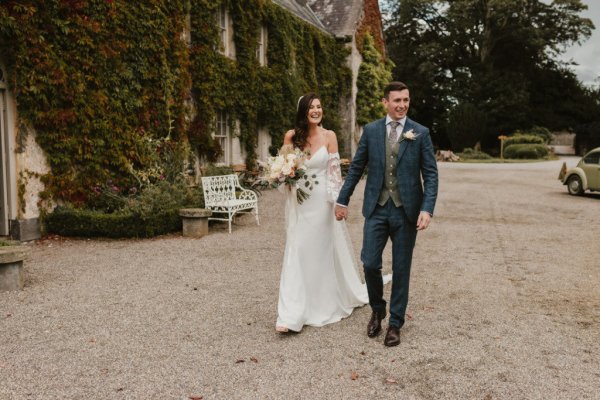 Bride and groom walking hand in hand holding hands