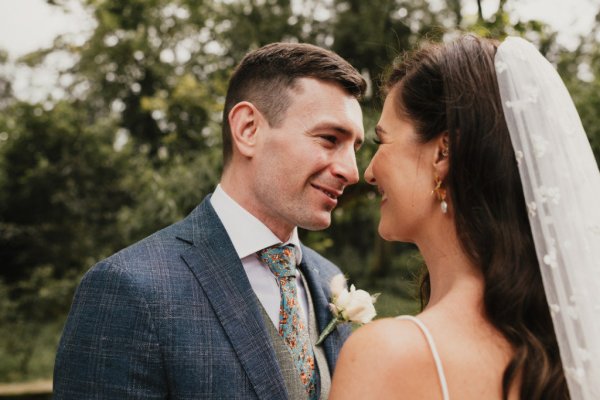 Bride groom laughing looking at each other