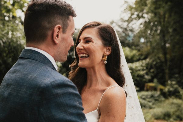 Bride groom laughing looking at each other