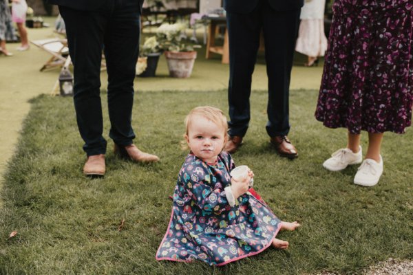 Little baby girl sitting on grass