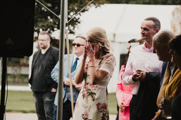 Guests celebrating couple crying laughing