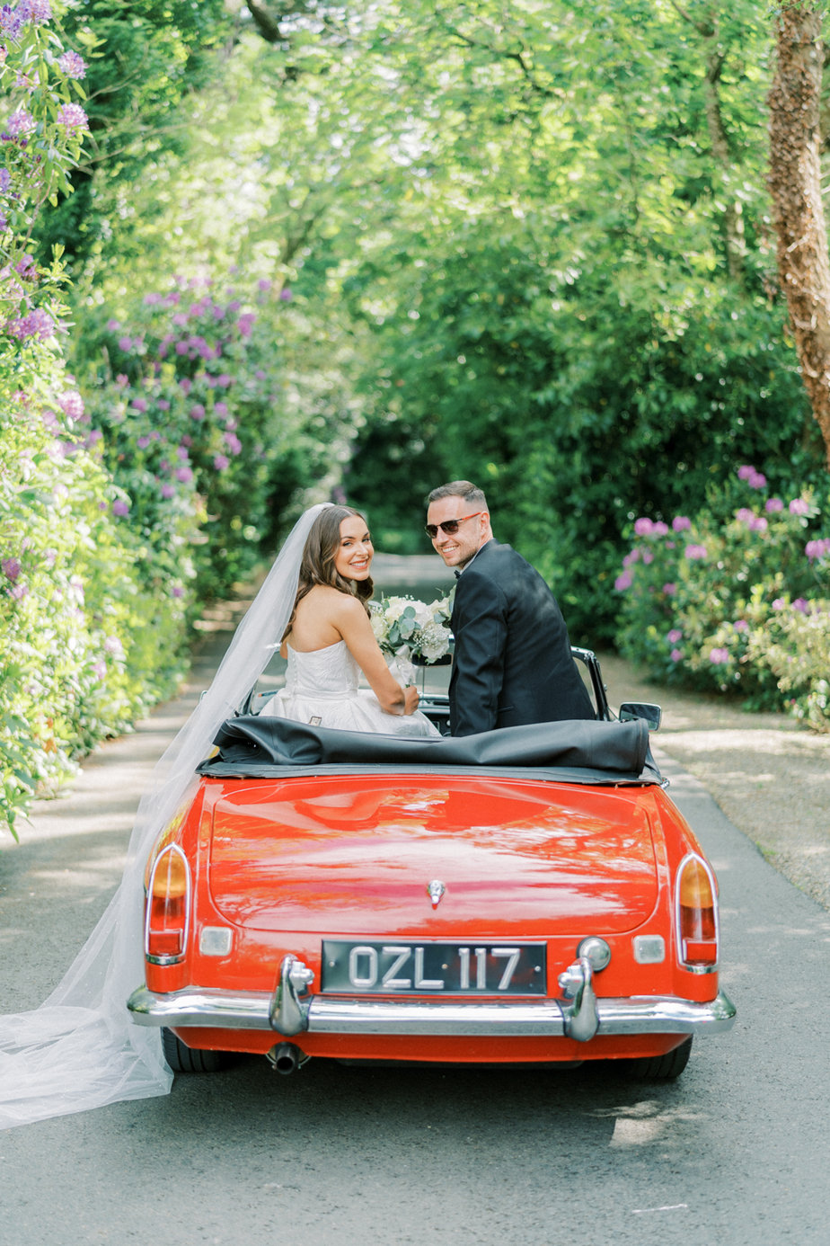 Just wed red wedding car bouquet of flowers bride groom