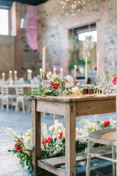 Interior ceremony ceremonial room dining roses red white flowers candle chairs champagne glasses