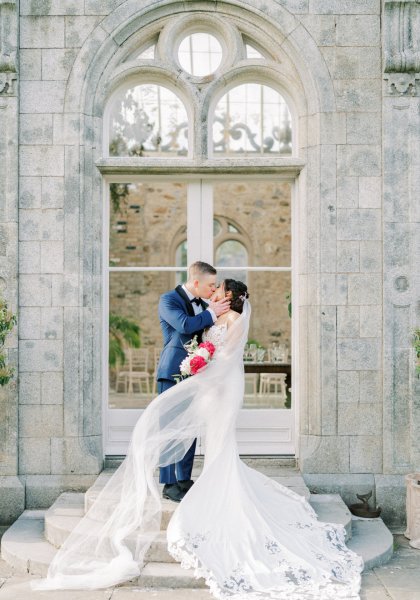 Bride groom exterior veil garden flowers