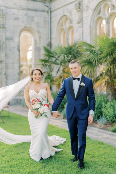 Bride groom exterior veil garden holding hands