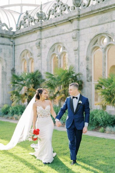 Bride groom exterior veil garden holding hands