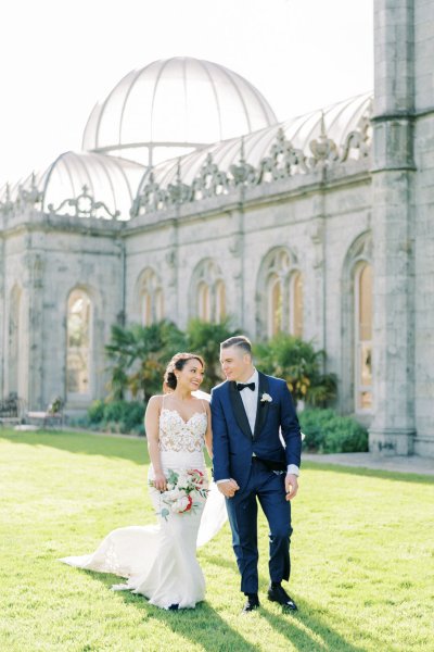 Bride groom exterior veil garden holding hands