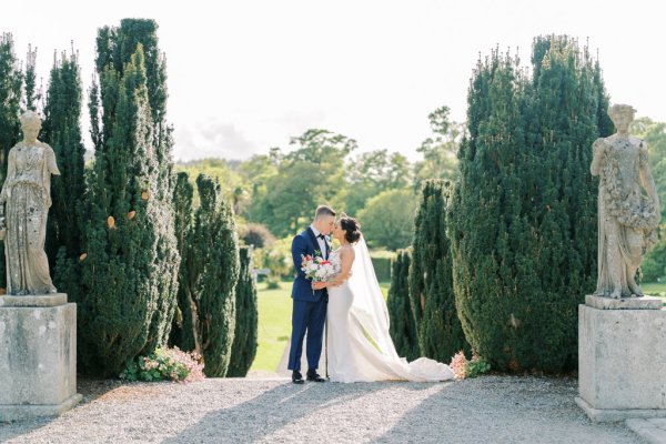 Bride groom exterior veil garden holding hands