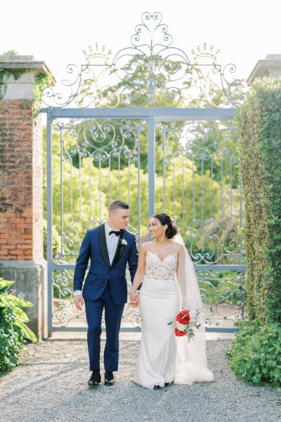 Bride groom exterior veil garden holding hands