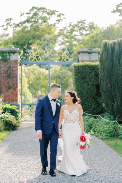 Bride groom exterior veil garden holding hands flowers bouquet