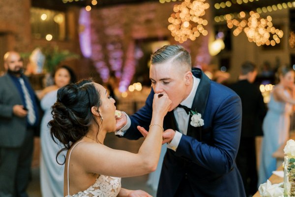 Bride and groom eat the cake