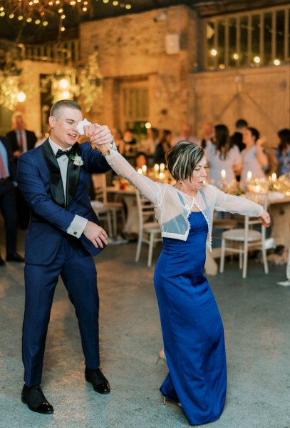 Guitarist wedding band play as groom and mother dance