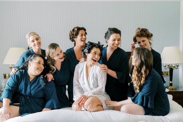 Bride and bridesmaids getting ready before wedding ceremony cheers