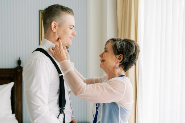 Groom and mother emotional getting ready