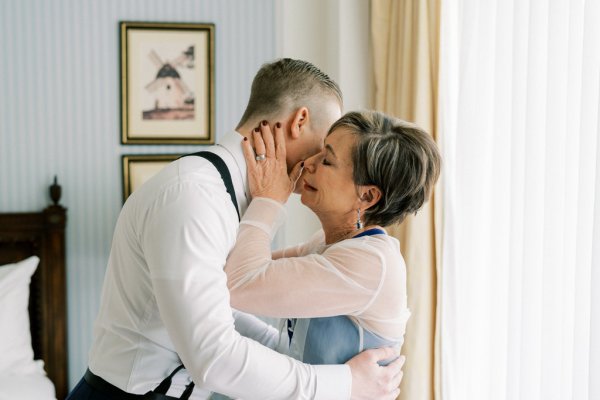 Groom and mother emotional getting ready