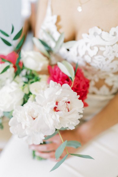 Bride smiles happy holding bouquet of flowers