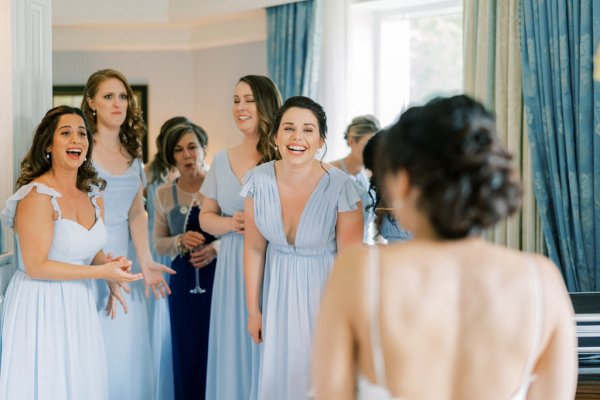 Bridesmaids look at bride blue dresses