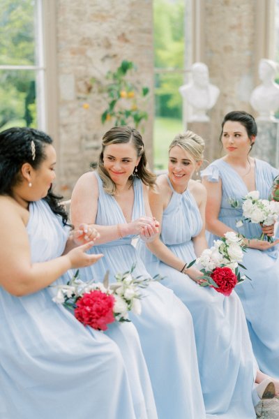 Bridesmaids sitting ceremony flowers bouquet