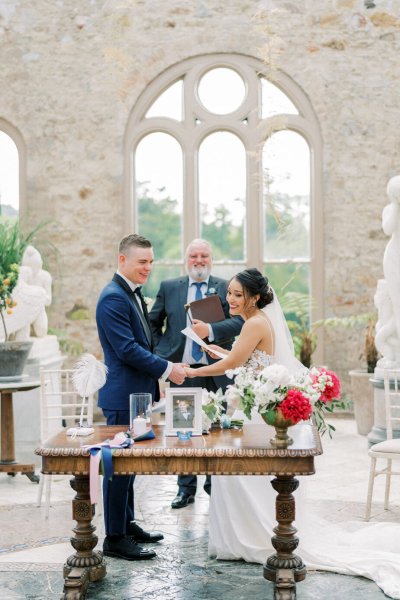 Bride groom wedding ceremony flowers guests aisle