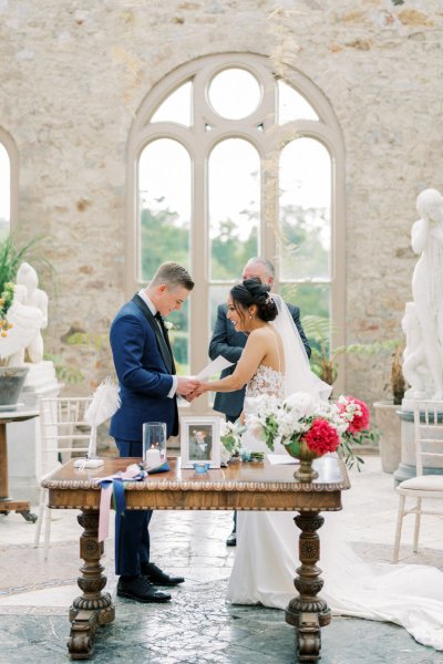 Bride groom wedding ceremony flowers guests aisle