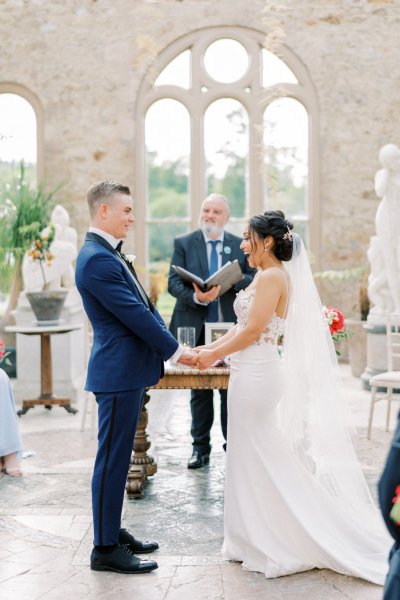 Bride groom wedding ceremony flowers guests aisle