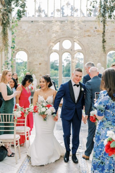 Bride groom wedding ceremony flowers guests aisle