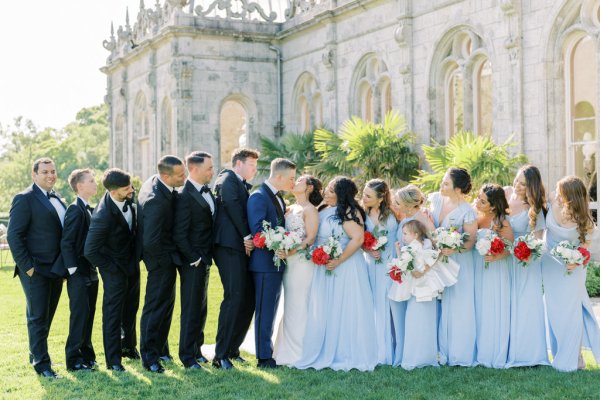 Blue bridesmaids dresses bride rose bouquet flowers with groomsmen groom