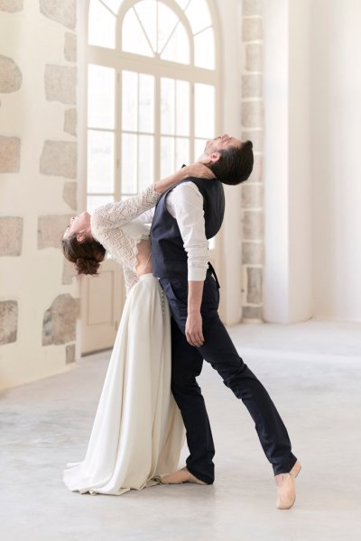 Groom and bride dancing in studio