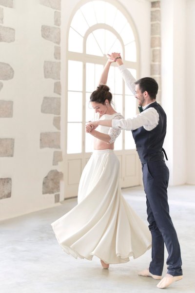 Groom and bride dancing in studio