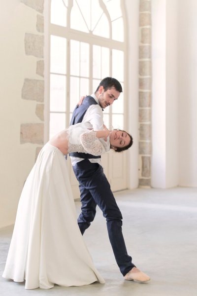 Groom and bride dancing in studio