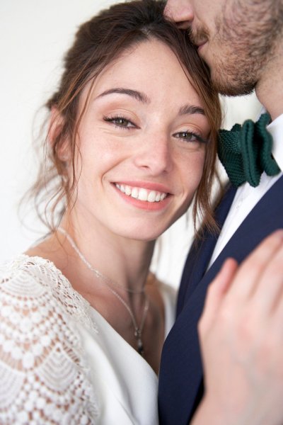 Bride groom embrace suit tie