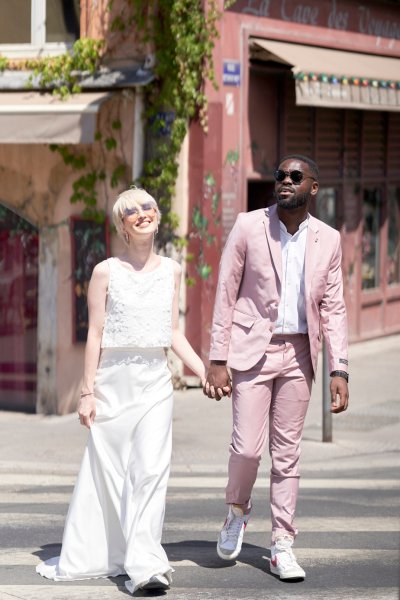 Bride groom pink suit crossing the road sunny sunshine